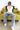 A model sitting on a olive green couch with his hands spread wide wearing Adventures Donald Duck Jersey Zoomed Out Front View from Bonkers Corner